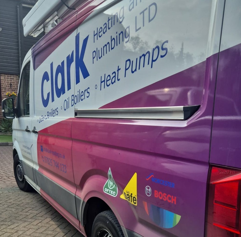 Close-up of the Clark Heating and Plumbing van showing OFTEC, Gas Safe, Worcester and Bosch accreditations